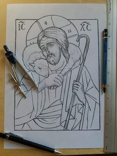 a drawing of jesus holding the cross on top of a table next to a pen and ruler