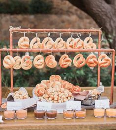 a table topped with lots of doughnuts and other food on top of it