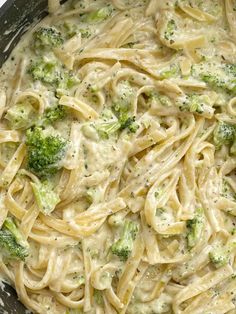 a pan filled with pasta and broccoli covered in cheese