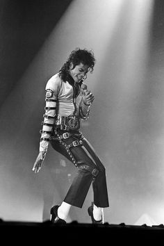 michael jackson performing on stage with his hands in the air