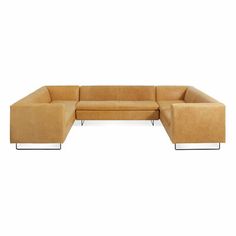 a tan leather sectional sofa with metal legs