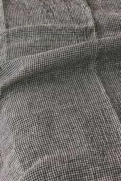 the fabric is made up of black and white checkered material, with small squares on it