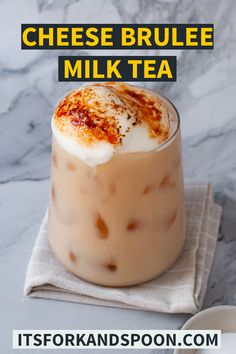 a drink in a glass with whipped cream on top and the words cheese brulee milk