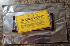 a piece of wax paper sitting on top of a metal foil bag with a yellow label