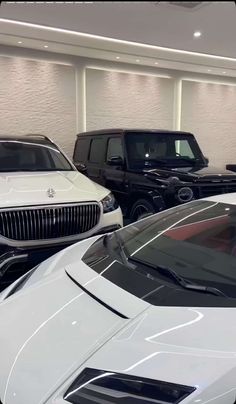 several luxury cars are parked in a showroom