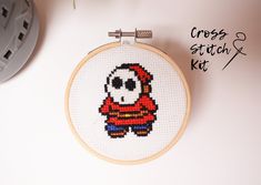 the cross stitch kit is ready to be sewn and decorated with an image of a skeleton