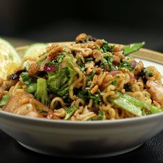 a white bowl filled with noodles and vegetables