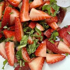 a salad with strawberries and greens on a plate