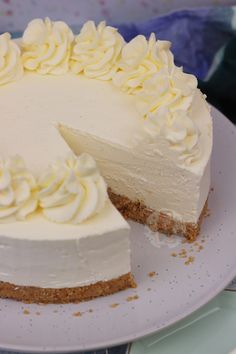 a white cake on a plate with one slice cut out and ready to be eaten