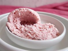 a white bowl filled with pink ice cream