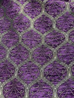 an intricate purple and silver design on fabric