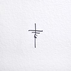 a cross is drawn on the side of a white wall with chinese writing in black ink