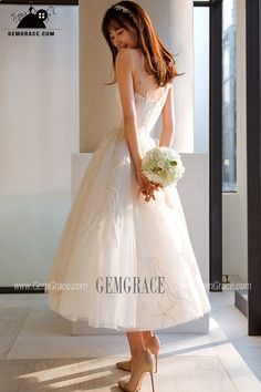 a woman in a white dress holding a bouquet