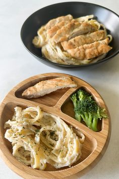 some food is in a bowl on a table next to another plate with bread and broccoli