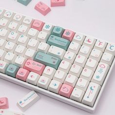 a white keyboard with pink and blue keys