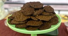 a green plate filled with chocolate cookies on top of a table