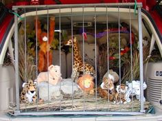 several stuffed animals are in a caged area