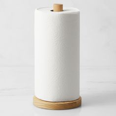 a roll of toilet paper sitting on top of a wooden holder