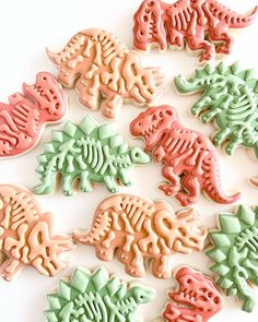 dinosaur cookies decorated with fondant icing on a white surface