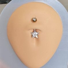 a white dummy with a silver star on it's nose and an earring