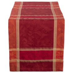 a red table runner with an intricate design on the top and bottom, set against a white background