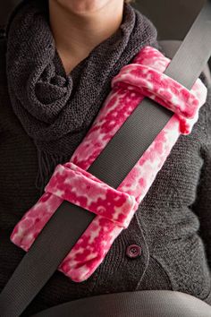 a woman wearing a pink and black tie dye car seat belt