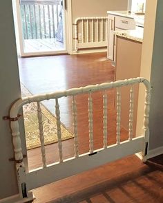 an open door leading to a kitchen and living room with hardwood floors in the background