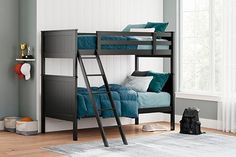 a bunk bed with a ladder and blue pillows on the bottom level, in a room with hardwood floors