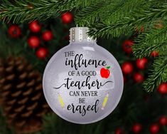 an ornament hanging from a christmas tree that says the influence of a good teacher can never be engaged