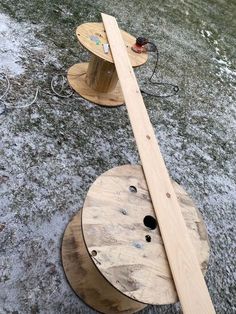 two wooden spools sitting on top of each other in the middle of a field