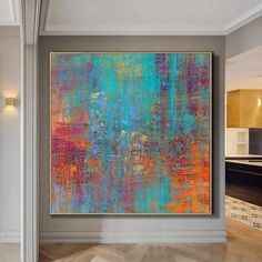 an abstract painting hangs on the wall in this modern living room