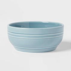 a blue bowl sitting on top of a white table