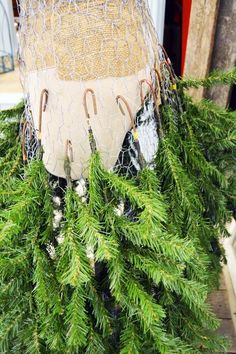 a pile of pine branches with fishing nets attached to the top and hooks on each end