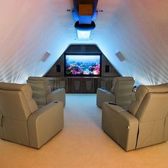 two recliner chairs in front of a flat screen tv inside an airplane's cabin