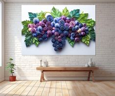 a painting of grapes on a white wall