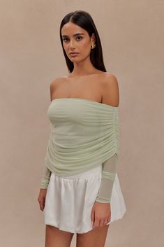 Elegant showstopper.The EVERLY Sheer Mesh Off Shoulder Top exudes elegance and modern style. This top features an off-the-shoulder design and long sleeves, creating a sophisticated silhouette. Made from delicate mesh fabric, it offers a sheer look with a ruched overlay that adds texture and visual interest. The longline cut ensures a flattering fit, making it a versatile piece for both casual and dressy occasions. Embrace chic fashion with the Everly Sheer Off Shoulder Mesh Top. Off Shoulder Top, Chic Fashion, Pastel Green, Shoulder Design, Off Shoulder Tops, Long A Line, Mesh Fabric, Mesh Top, Latest Fashion Trends