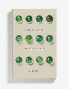 a book cover with green marbles on the front and bottom, in white paper