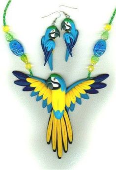 a blue and yellow bird necklace and earring set