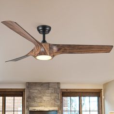 a living room with a fireplace and ceiling fan