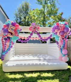 an inflatable bed is decorated with balloons and streamers