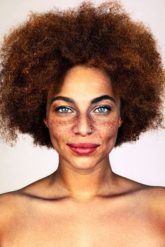 a woman with frizz on her face and red hair is looking at the camera