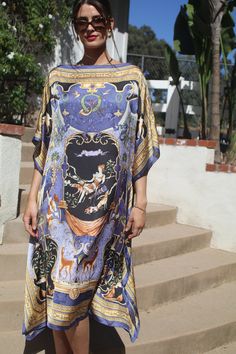 Elegant womens caftan/dress in a beautiful traditional print.  Soft, silky, medium weight,  poly fabric, not see through.  Great for traveling, will arrive wrinkle free. Can be worn alone or with pants or skirts. One size.  Fits small to large sizes.  The width is 42 inches edge to edge, 84 inches around the body, the side seams are five inches from the edge, giving 64 inches for body room and elegant, flowing movement.  The length is 42 inches, falling longer at the sides.  Hand wash, hang to dry. Swimsuit Coverups Kimono, Ladies Caftan, Wrap Swimsuit, Kaftan Maxi Dress, Long Kaftan, Long White Dress, Silky Dress, Long Kimono, Womens Kimono