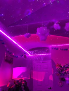 a room with purple lighting and decorations on the ceiling