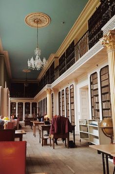 an empty library filled with lots of furniture and bookshelves on either side of the room