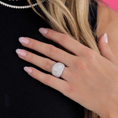 a woman's hand with a diamond ring on it