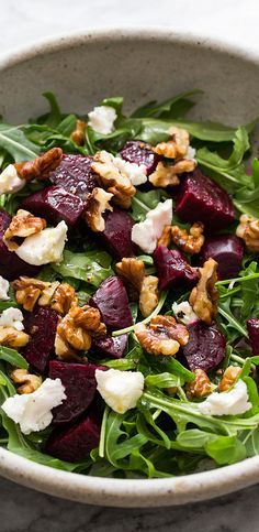 a salad with beets and goat cheese in a bowl