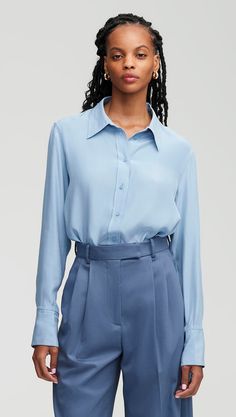 Made of a lightweight silk charmeuse, this slim fit blouse is bound to be your new go-to. The long-length button-up features lined lapels, a silk charmeuse combo lining the cuffs, and side slit hems. Wear this top partially tucked, fully tucked, or untucked with your favorite pair of trousers. Slim Blouse, Trousers Details, Belted Blazer, Fitted Blouses, Work Wear Women, Silk Charmeuse, Slate Blue, Dress Suits, Blue Blouse