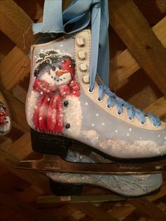 a pair of ice skates decorated with snowmen