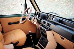 the interior of an old car with tan leather seats and steering wheel, dashboard, and dash board