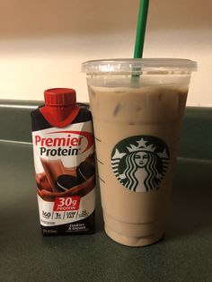 a cup of coffee next to a carton of protein drink